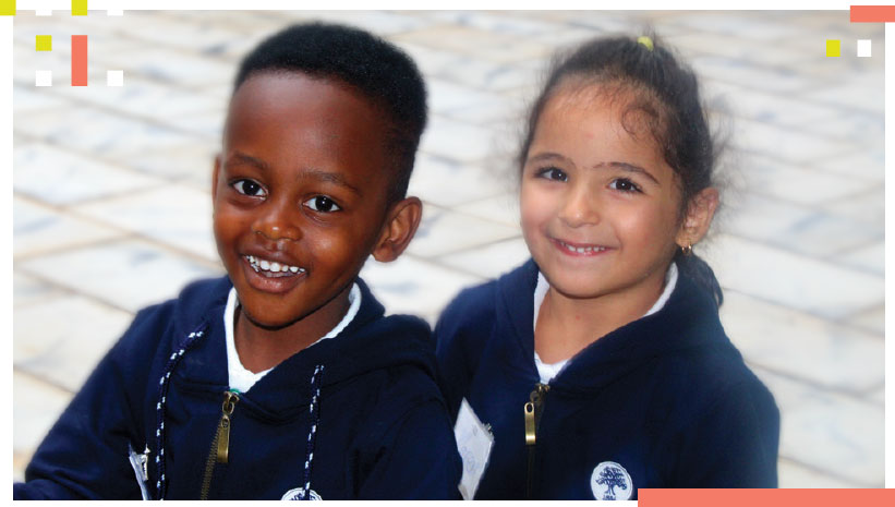 Two young students smiling for a photo 