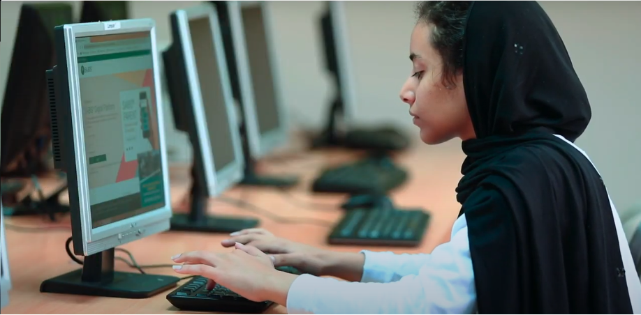 Student typing on computer keyboard